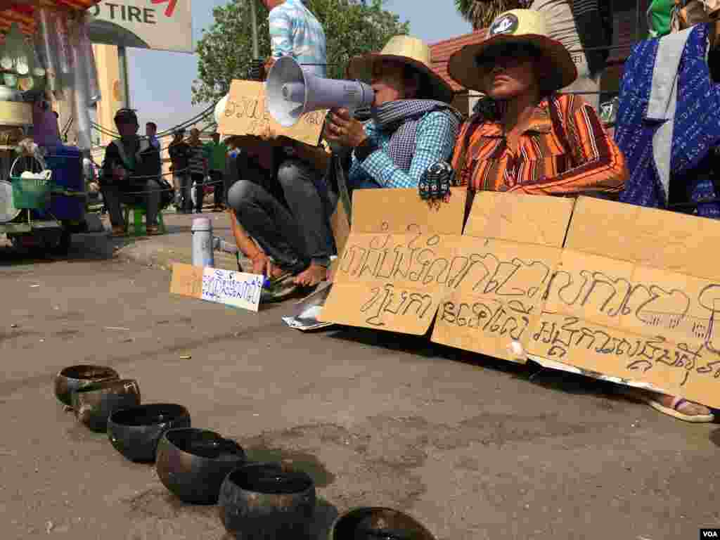 កុ្រមសកម្មជនដីធ្លីតវ៉ាប្រឆាំងនឹងការសួរយកចម្លើយពីមន្ត្រីសិទ្ធិមនុស្សសមាគមសិទ្ធិមនុស្សអាដហុក និងមន្ត្រីគណកម្មាធិការជាតិរៀបចំការបោះឆ្នោត ដែលធ្វើឡើងដោយតុលាការដំបូងក្រុងភ្នំពេញ កាលពីថ្ងៃអាទិត្យ ទី០១ ខែឧសភា ឆ្នាំ២០១៦។ (Hul Reaksmey/VOA)