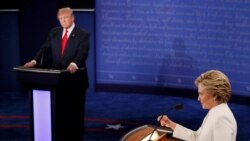 Republican presidential nominee Donald Trump listens as Democratic presidential nominee Hillary Clinton speaks during their third and final 2016 presidential campaign debate at UNLV in Las Vegas, Oct. 19, 2016.