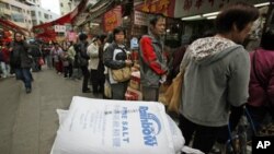 Customers line up outside a store in Hong Kong March 17, 2011, as shoppers in the Chinese territory rush to buy salt, which they believe could help to protect them from radiation.