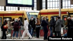 FILE - Passengers wear face masks at Friedrichstrasse station during COVID-19 lockdown in Berlin, July 21, 2021