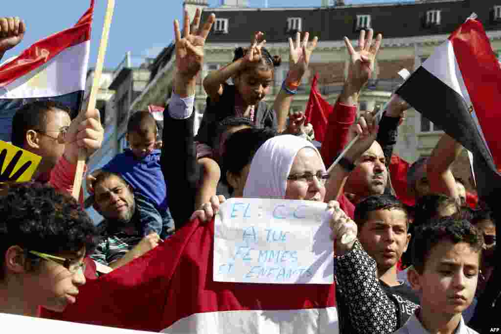 A protester displays a banner during a rally in front of the Egyptian embassy in Tokyo on August 18, 2013. 