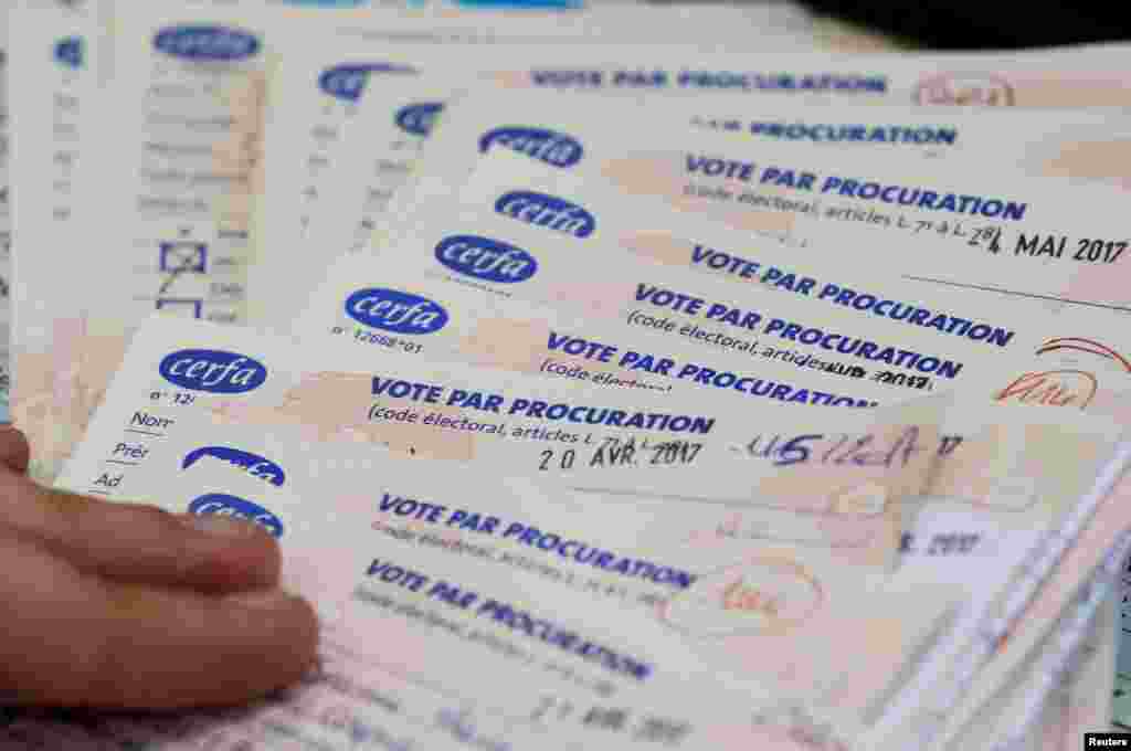 A municipal employee verifies absentee ballots on the eve of the second round of the French presidential election, at a polling station in Tulle, May 6, 2017.