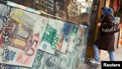 FILE - A woman enters a currency exchange shop in Tehran's business district, Oct. 24, 2011. 