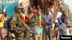 DRC soldiers, part of an African peacekeeping force, patrol along a street in Bangui, Feb. 12, 2014. 