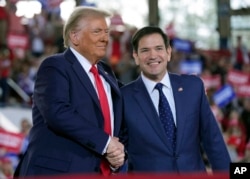 FILE - Donald Trump greets Senator Marco Rubio during a campaign rally at J.S. Dorton Arena, Nov. 4, 2024, in Raleigh, North Carolina. Trump, now president-elect, has tapped Rubio to become U.S. secretary of state.