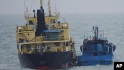 FILE - This photo released by Japan's Ministry of Defense shows what it says is the North Korean-flagged tanker Yu Jong 2, left, and Min Ning De You 078 lying alongside in the East China Sea, Feb. 16, 2018. 