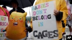 Protesters hold an inflatable doll in the likeness of President Donald Trump outside of the Homestead Temporary Shelter for Unaccompanied Children, June 16, 2019, in Homestead, Fla.
