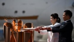 A scene from the torch relay earlier in 2021. People typically wonder who will light the cauldron in the Olympic stadium. (Photo by Philip FONG / AFP)