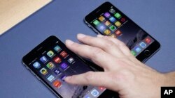The iPhone 6 plus, at left, and iPhone 6 are displayed on Sept. 9, 2014, in Cupertino, Calif. 
