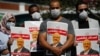 People hold posters of slain Saudi journalist Jamal Khashoggi, near the Saudi Arabian Consulate in Istanbul, marking the two-year anniversary of his death, Oct. 2, 2020.