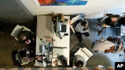 In this January 11, 2019, photo, women work in a lower-level space at The Riveter, a women-centered shared workspace business in Seattle.