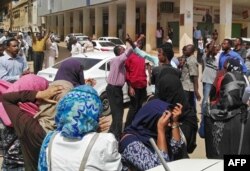 FILE - Sudanese protesters take part in an anti-government demonstration in Khartoum, Feb. 14, 2019.