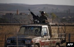 A Jordanian soldier keeps watch at the border between Syria and Jordan, near the town of Nasib in southern Syria, July 2, 2018.