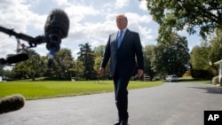 President Donald Trump talks to reporters as he walks to board Marine One on the South Lawn of the White House, Wednesday, Sept. 27, 2017, in Washington.