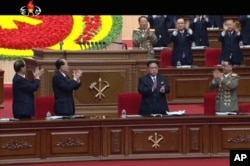 In this frame taken from TV, North Korean leader Kim Jong Un, center, applauds during the ruling party congress in Pyongyang, North Korea, May 7, 2016.