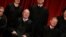 FILE - U.S. Supreme Court Justice Anthony Kennedy (L) reacts while chatting with Chief Justice John Roberts (R) during a photo session with fellow justices at the Supreme Court building in Washington, June 1, 2017. 