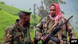 A picture taken on June 3, 2012 shows rebels of the mutinous armed force known as M23 patrolling on the hill of Kavumu in North Kivu, Democratic Republic of the Congo (DRC).