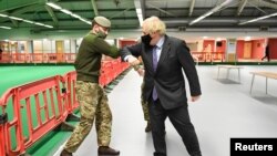 British Prime Minister Boris Johnson meets troops as they set up a vaccination centre in the Castlemilk district of Glasgow, Scotland, Britain, Jan. 28, 2021.