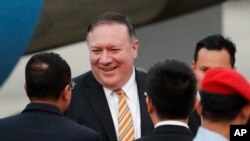 U.S. Secretary of State Michael Pompeo is greeted by local officials as he arrives at the military airport in Subang, outside of Kuala Lumpur, Malaysia, Aug. 2, 2018.