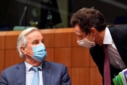 EU chief Brexit negotiator Michel Barnier, left, speaks with France's Permanent Representative to the EU Philippe Leglise-Costa during a meeting of ambassadors of European Union governments in Brussels, Dec. 7, 2020.