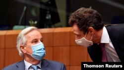 EU chief Brexit negotiator Michel Barnier speaks with France's Permanent Representative to the EU Philippe Leglise-Costa during a meeting of ambassadors of European Union governments in Brussels, Belgium Dec. 7, 2020.