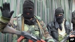 People gather front of the bombed office of This Day, an influential daily newspaper in Abuja, Nigeria, April. 26, 2012. (AP)