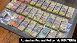 Money seized by Australian Federal Police are seen after its Operation Ironside against organised crime in this undated handout photo released June 8, 2021. Australian Federal Police/Handout via REUTERS 