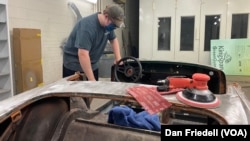 Charles Wilkinson works on his car at Edison Academy's auto shop.
