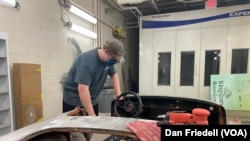 Charles Wilkinson works on his car at Edison Academy's auto shop.