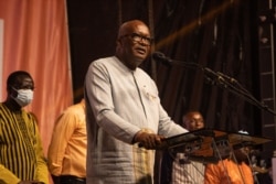 FILE - Burkina Faso President Roch Marc Christian Kabore addresses supporters during a celebration at his party’s headquarters in Ouagadougou, Nov. 26, 2020.