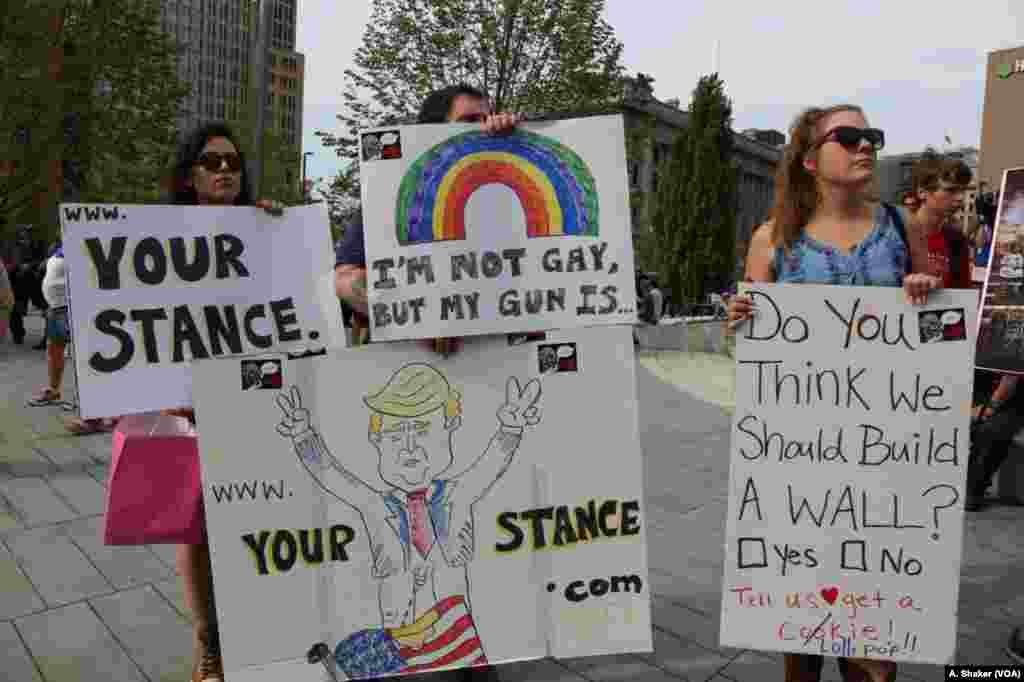 Anti-Trump protesters hold signs during the Republican National Convention, in Cleveland, July 21, 2016. 