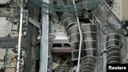 A derailed New Jersey Transit train is seen under a collapsed roof after it derailed and crashed into the station in Hoboken, New Jersey, Sept. 29, 2016. 