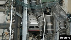 FILE - A derailed New Jersey Transit train is seen under a collapsed roof after it derailed and crashed into the station in Hoboken, New Jersey, Sept. 29, 2016. 