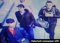 FILE - In this photo made from a video, people believed to be the attackers walk in Istanbul's Ataturk airport, June 28, 2016.