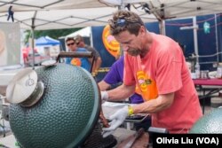 Chris Capell inspects pork ribs that had been cooking on the grill at the National Capital Barbecue Battle in Washington D.C. on Sunday, June 25, 2017. Capell is the pitmaster for Dizzy Pig, a barbecue company in Virginia.