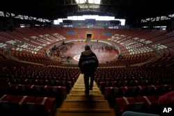 A Central American migrant, part of the caravan hoping to reach the U.S. border, arrives at the Benito Juarez Auditorium that is being as a migrant shelter, in Guadalajara, Mexico, Nov. 12, 2018.