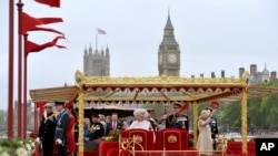 Queen Elizabeth II with other members of the Royal family watch the Diamond Jubilee Pageant on the River Thames in London.