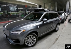 An FILE - An Uber driverless car heads out for a test drive in San Francisco, Dec. 13, 2016.