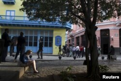 A tourist reads a guidebook in old Havana, Cuba, Jan. 17, 2016.