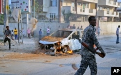 FILE - A Somali soldier attends the scene after a bomb attack near the office of the International Committee of the Red Cross in Mogadishu, Somalia, March 28, 2018.