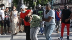 Police take away a protester on Sunday in Cuba.