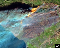 A false-color image from the European Space Agency's Sentinel-2 satellite via NASA shows a brown burn scar from the Thomas fire north of the city of Ventura, California, at bottom center, Dec. 7, 2017.