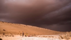In this undated photo provided by the Palaeodeserts Project in September 2021, a storm arrives during an archaeological excavation of the remains of an ancient lake in northern Saudi Arabia, where ancient humans lived alongside animals such as hippos. (Klint Janulis/Palaeodeserts Project via AP)