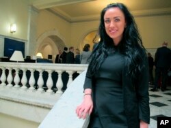 Maryland Del. Meagan Simonaire poses in the Maryland State House in Annapolis, Md., May 15, 2018, after Maryland Gov. Larry Hogan signed legislation to ban gay conversion therapy for minors. Simonaire, a Republican, spoke on the House floor last month about the pain she experienced when her parents looked into the therapy for her when she told them she was bisexual. Her father, state Sen. Bryan Simonaire, voted against the measure days before she voted for the ban.