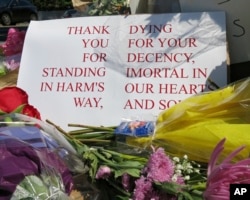 A sign of thanks rests against a traffic light pole at a memorial outside the transit center in Portland, Oregon, May 27, 2017.