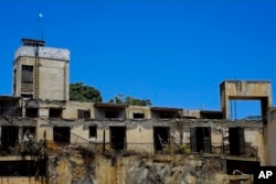 An abandoned building with a guard post with a U.N. flag on top in the U.N. buffer zone that divides the Greek and Turkish Cypriots controlled areas in central divided capital Nicosia, Cyprus, June 30, 2017.