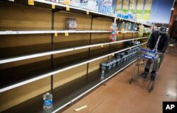 Shelves of bottles of water sit mostly empty at a supermarket in Atlanta, Jan. 6, 2017. Shoppers emptied shelves of bread and milk, and states of emergency were declared in Alabama, Georgia and the Carolinas ahead of a winter storm.
