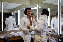Dwight Icenhower, right, applies makeup to Ben Portsmouth at the "Images of the King: Las Vegas" festival in Las Vegas, July 15, 2017.