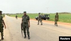 A still image taken from a video shot on June 25, 2018, shows security officers on the street in Plateau, Nigeria.