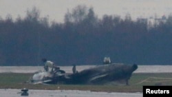 The wreckage of what is believed to be Christophe de Margerie's Dassault Falcon jet is seen at Moscow's Vnukovo airport, Oct. 21, 2014.